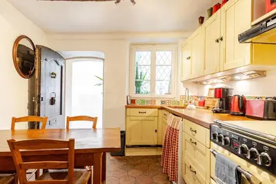 a kitchen with a table and a stove top oven at 
