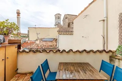 a wooden table and chairs on a balcony at 