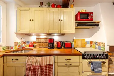 a kitchen with wooden cabinets and a red microwave at 