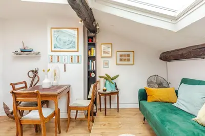 a living room with a green couch and a table at 