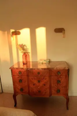 a wooden dresser with a lamp on top of it at Appartement Élégant avec Balcon Centre Cannes in Cannes