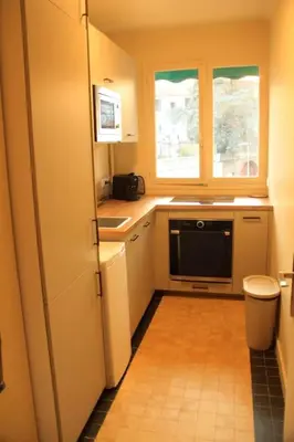 a small kitchen with a sink and a microwave at Appartement Élégant avec Balcon Centre Cannes in Cannes