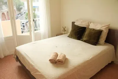 a bedroom with a bed with two towels on it at Appartement Élégant avec Balcon Centre Cannes in Cannes