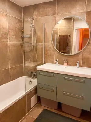 a bathroom with a sink and a shower and a mirror at Appartement Élégant avec Balcon Centre Cannes in Cannes