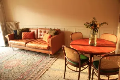 a living room with a couch and a table at Appartement Élégant avec Balcon Centre Cannes in Cannes