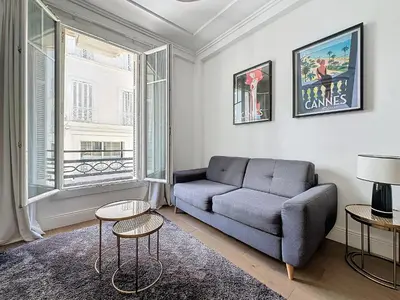 a living room with a couch and a large window at INTUITION - 2 pieces - Cannes Carre d or in Cannes
