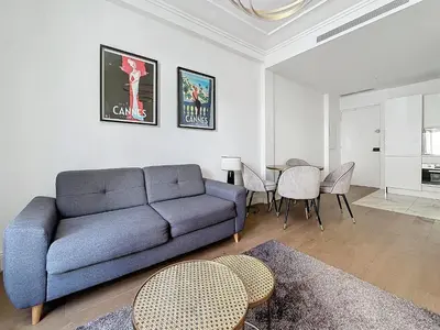 a living room with a blue couch and a table at INTUITION - 2 pieces - Cannes Carre d or in Cannes