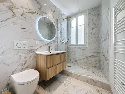 a bathroom with a toilet and a sink and a mirror at INTUITION - 2 pieces - Cannes Carre d or in Cannes