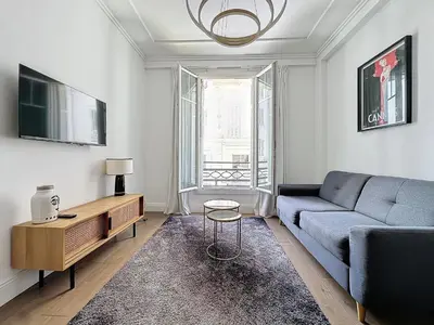 a living room with a couch and a tv at INTUITION - 2 pieces - Cannes Carre d or in Cannes