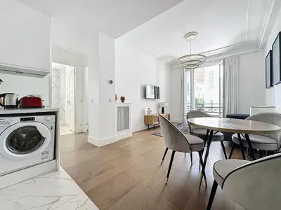 a white living room with a table and a dining room at INTUITION - 2 pieces - Cannes Carre d or in Cannes