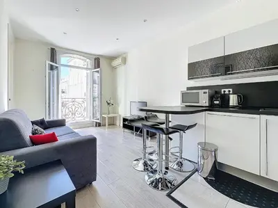 a kitchen and living room with a couch and a table at Intuition 2 lits 2'' Croisette et Palais des Festivals in Cannes