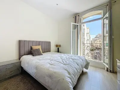 a bedroom with a bed and a large window at Intuition 2 lits 2'' Croisette et Palais des Festivals in Cannes