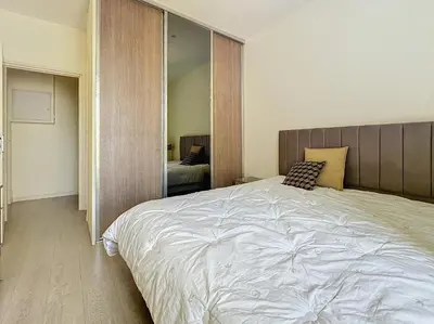 a bedroom with a large white bed and a mirror at Intuition 2 lits 2'' Croisette et Palais des Festivals in Cannes