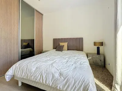 a bedroom with a bed and a large mirror at Intuition 2 lits 2'' Croisette et Palais des Festivals in Cannes