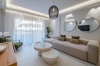 a living room with a couch and a table and mirrors at Beautiful 3 bedroom fully renovated in Cannes