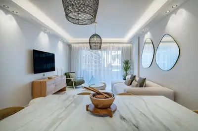 a living room with a couch and a table at Beautiful 3 bedroom fully renovated in Cannes