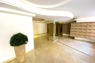 a large room with a potted plant in a building at Cosy 2 pièces - Palais Croisette Cannes in Cannes