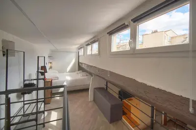 a room with a bed and two windows at Immogroom - T3 - Suquet - AC in Cannes