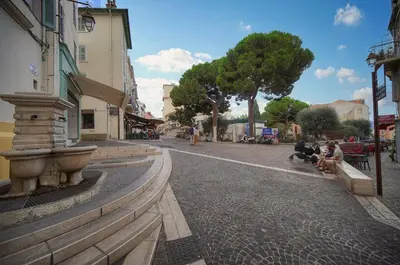 a street in a city with people sitting on benches at Immogroom - T3 - Suquet - AC in Cannes