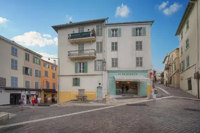 a large white building on a street with people walking at Immogroom - T3 - Suquet - AC in Cannes