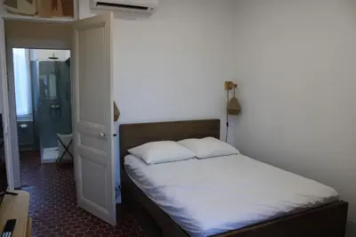 a bed with two pillows on it in a bedroom at Cocon Spacieux équipé Quartier Prado in Cannes
