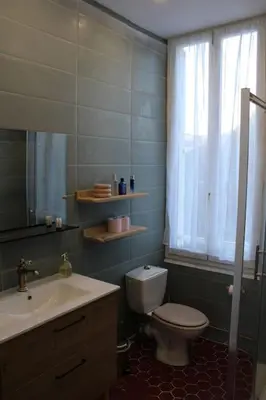 a bathroom with a toilet and a sink and a window at Cocon Spacieux équipé Quartier Prado in Cannes