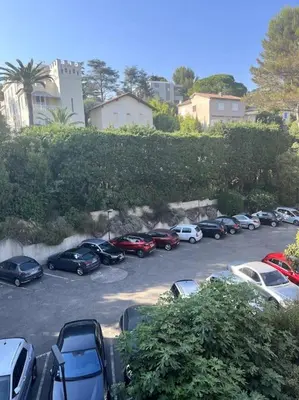 a bunch of cars parked in a parking lot at Studio calme avec vue sur un grand Pin parasol in Cannes