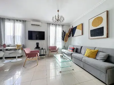 a living room with a couch and a table at INTUITION - Cannes centre - 6-8 Couchages in Cannes