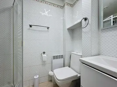 a white bathroom with a toilet and a shower at INTUITION - Cannes centre - 6-8 Couchages in Cannes