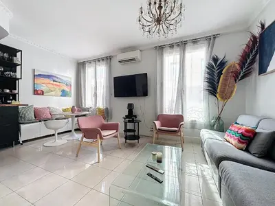 a living room with a couch and a table at INTUITION - Cannes centre - 6-8 Couchages in Cannes