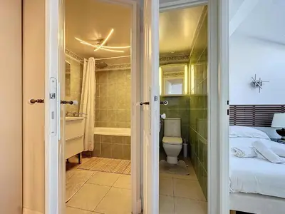 a bathroom with a bed and a toilet in a room at INTUITION - Cannes centre - 6-8 Couchages in Cannes