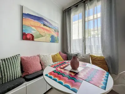 a living room with a table and a couch at INTUITION - Cannes centre - 6-8 Couchages in Cannes