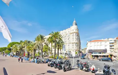 a city street with motorcycles parked in front of a building at Nice Apartment In Cannes With Wifi in Cannes