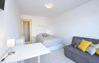 a white room with a bed and a couch and a bed at Nice Apartment In Cannes With Wifi in Cannes