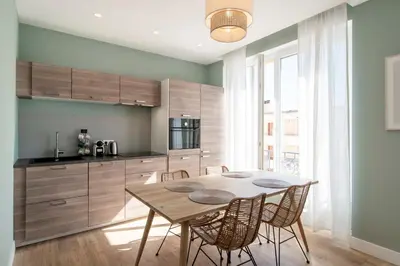 a kitchen with a table and chairs in a room at REF 1943 - Cannes Centre - Apartment for rent in Cannes