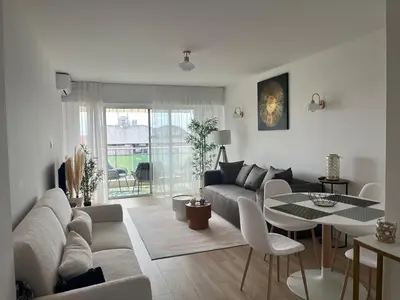 a living room with a couch and a table at Central Park Cannes in Cannes