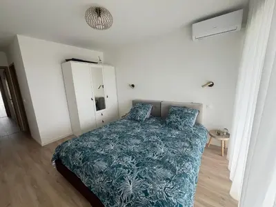a bedroom with a bed with a blue comforter at Central Park Cannes in Cannes