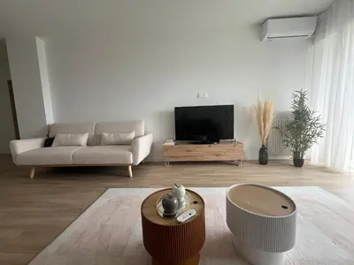 a living room with a couch and a television at Central Park Cannes in Cannes