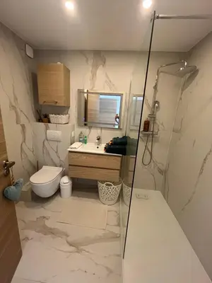 a bathroom with a sink and a toilet and a mirror at Central Park Cannes in Cannes