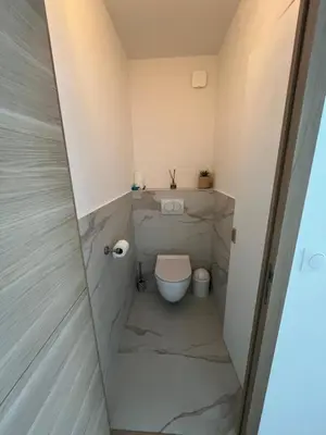a small bathroom with a toilet in the corner at Central Park Cannes in Cannes