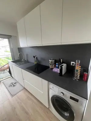 a kitchen with a washing machine and a counter top at Central Park Cannes in Cannes