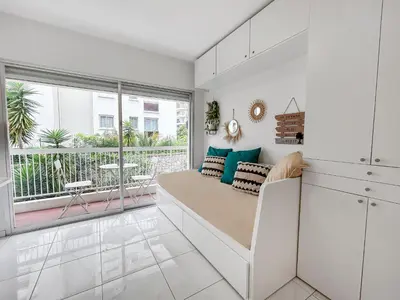 a living room with a couch and a large window at Studio lumineux, WIFI à deux pas de la Croisette in Cannes