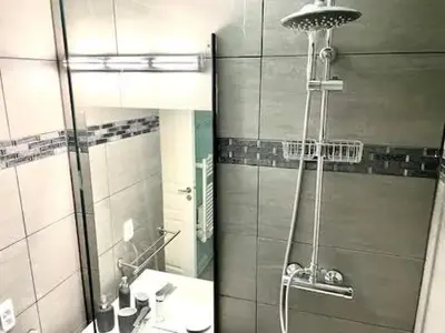 a bathroom with a shower and a sink and a mirror at Le Cannes Beach 408 - cosy Balcon Piscine Netflix in Cannes