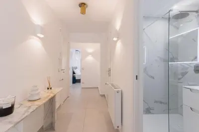 a white bathroom with a walk in shower and a sink at 7 Pradignac Full 3bdrs by Halldis in Cannes
