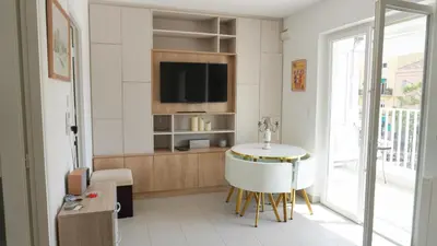 a living room with a table and a tv at Proche Palais Des Festivals - Croisette,Studio Bella - Palmazur Vacances in Cannes