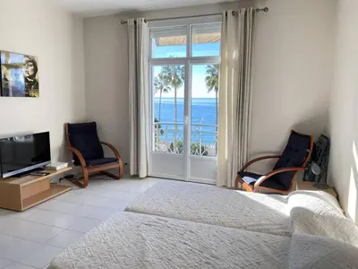 a bedroom with a bed and a view of the ocean at 204 - Cannes La Croisette - Studio face mer avec balcon in Cannes