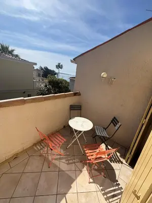 a patio with a table and chairs on a balcony at Villa Tricia Cannes in Cannes