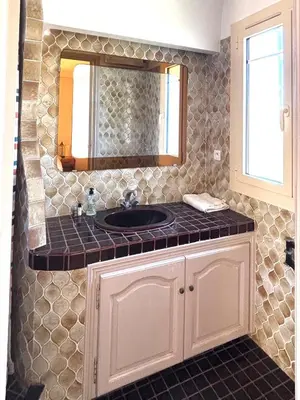 a bathroom with a sink and a mirror at Villa Tricia Cannes in Cannes