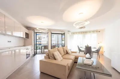 a living room with a couch and a table at 3-Br Apartment with Pool Parking & Beaches 100m away in Cannes