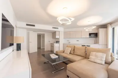 a living room with a couch and a table at 3-Br Apartment with Pool Parking & Beaches 100m away in Cannes